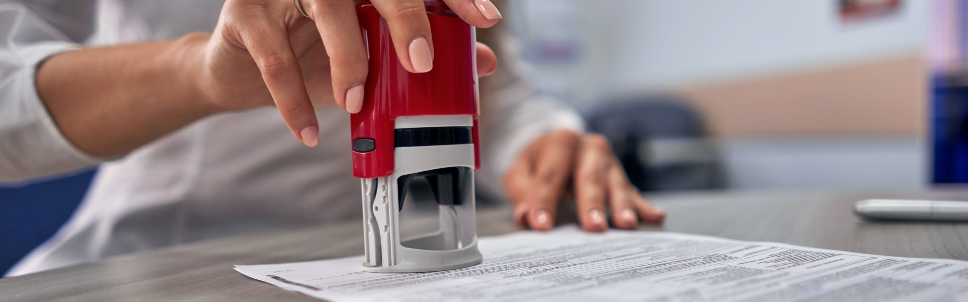 Person stamping a document